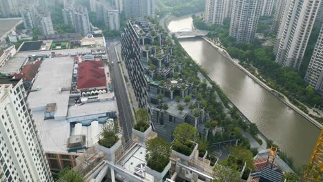 drone shot flying over shanghai futuristic 1000 trees shopping centre by thomas heatherwick in shanghai china