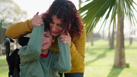 loving mother embracing her son in wheelchair