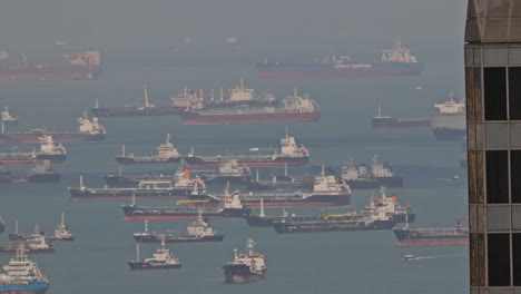 singapore - 5 march 2025 : container ships waiting in the sea by singapore