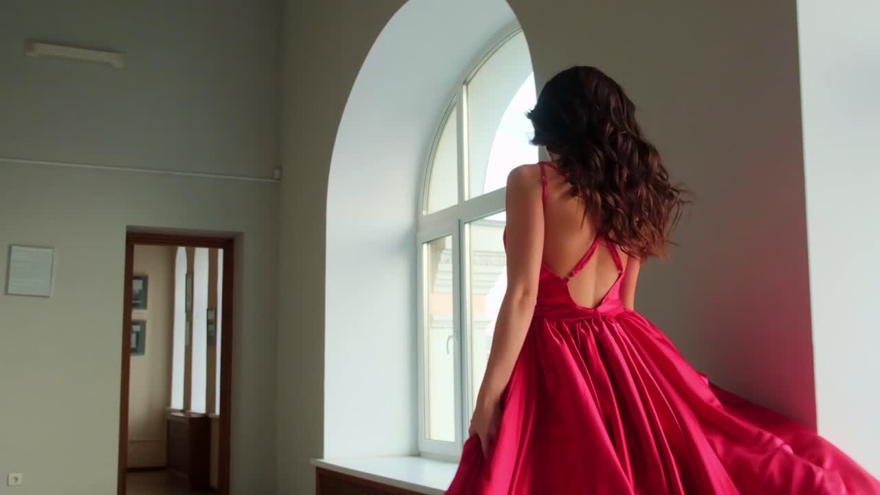 Elegant Woman in Flowing Red Dress Captured in Stunning Interior, Showcasing Motion and Graceful Beauty, Perfect for Fashion and Artistic Inspiration