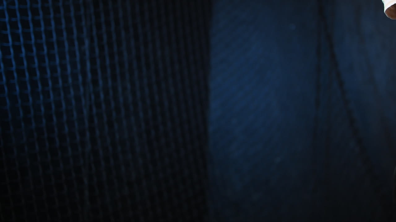 Isolated padel racket and ball hit impact in action against black background, 4k slow motion video footage