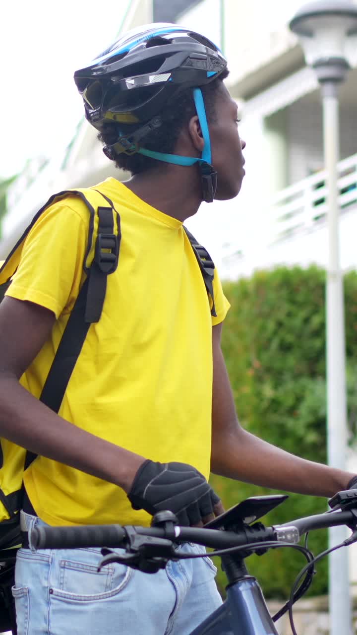 Delivery driver using mobile phone on bicycle