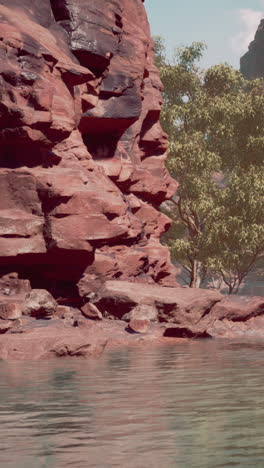 a scenic view of a red rock canyon with a river and a tree