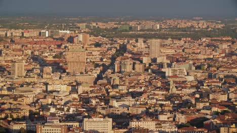 Milan-cityscape-and-Torre-Velasca-tower-during-golden-sunset,-view-from-above