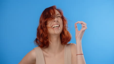 woman with red hair in a studio setting