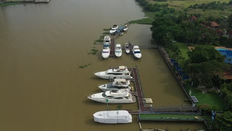 Fly-in-towards-river-marina-with-luxury-power-boats