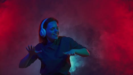woman dancing and listening to music in a colorful smoke-filled setting