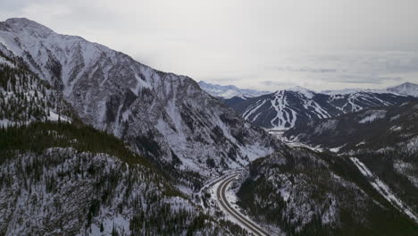 distant i70 copper mountain leadville colorado winter december christmas aerial drone cinematic landscape silverthorne vail aspen ten mile range cloudy rocky mountains upward reveal forward motion