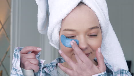 woman applying eye patches