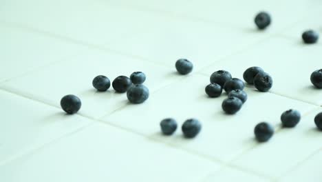 Blueberries-dropped-across-lclean-white-kitchen-counter