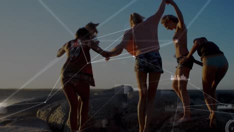 Animation-of-network-of-communication-over-female-friends-holding-hands-walking-on-beach