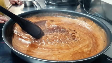 Mixing-boiling-sugar-and-butter-in-the-bowl