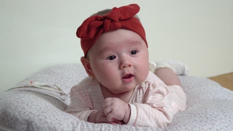 newborn infant baby girl drinking formula milk from the bottle close up