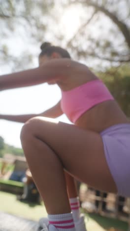 woman in athletic wear exercising outdoors