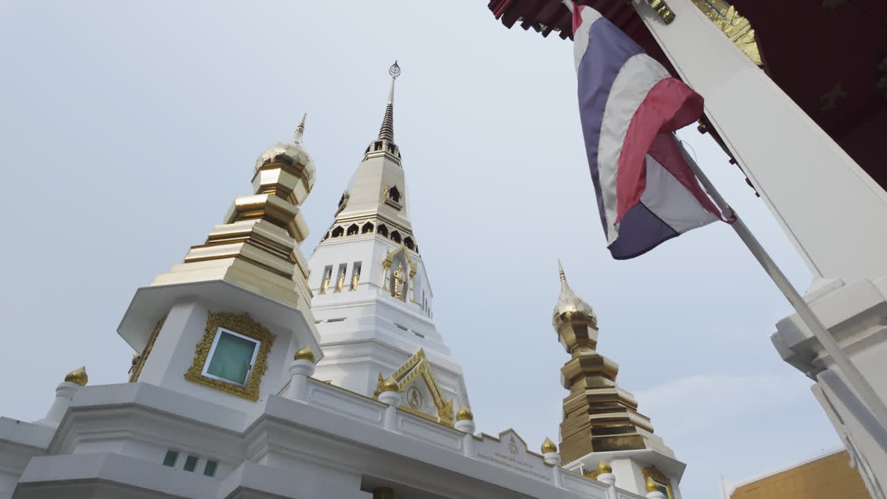 Exterior View Of Wat That Thong Temple With Flag of Thailand In Bangkok, Thailand. - tilt up shot
