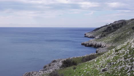 a steady shot of a beautiful rocky coastline on a summer day