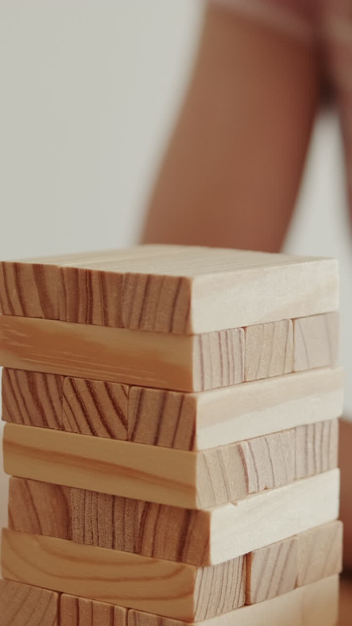 Woman Plays Wooden Block Game at Home
