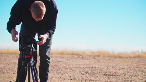 Male-Photographer-Filming-with-a-Tripod,-Cinematographer-Outside-in-Colorado