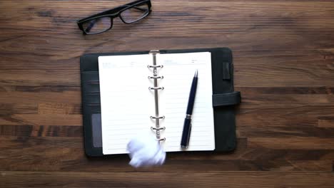 office workspace with planner and crumpled paper