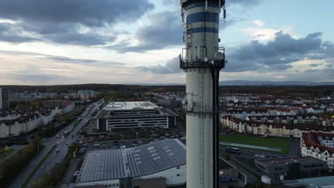 a tower in an industrial area with gsm antennas