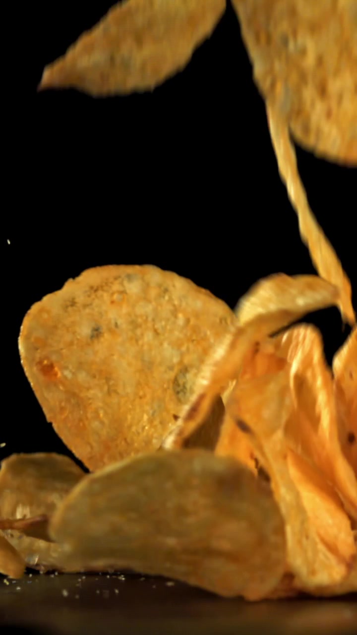 Crispy Golden Potato Chips Falling in Slow Motion