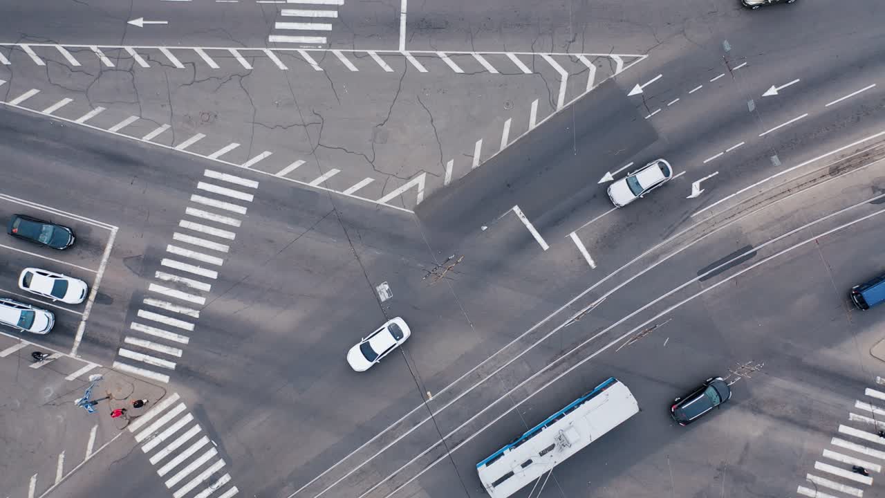 Large crossroads in the city. Cars, trams and pedestrians cross the road. Automobile traffic of urban transport.. Aerial drone top view