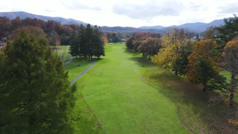 aerial shot flying down fairway on golf course at the greenbrier during autumn