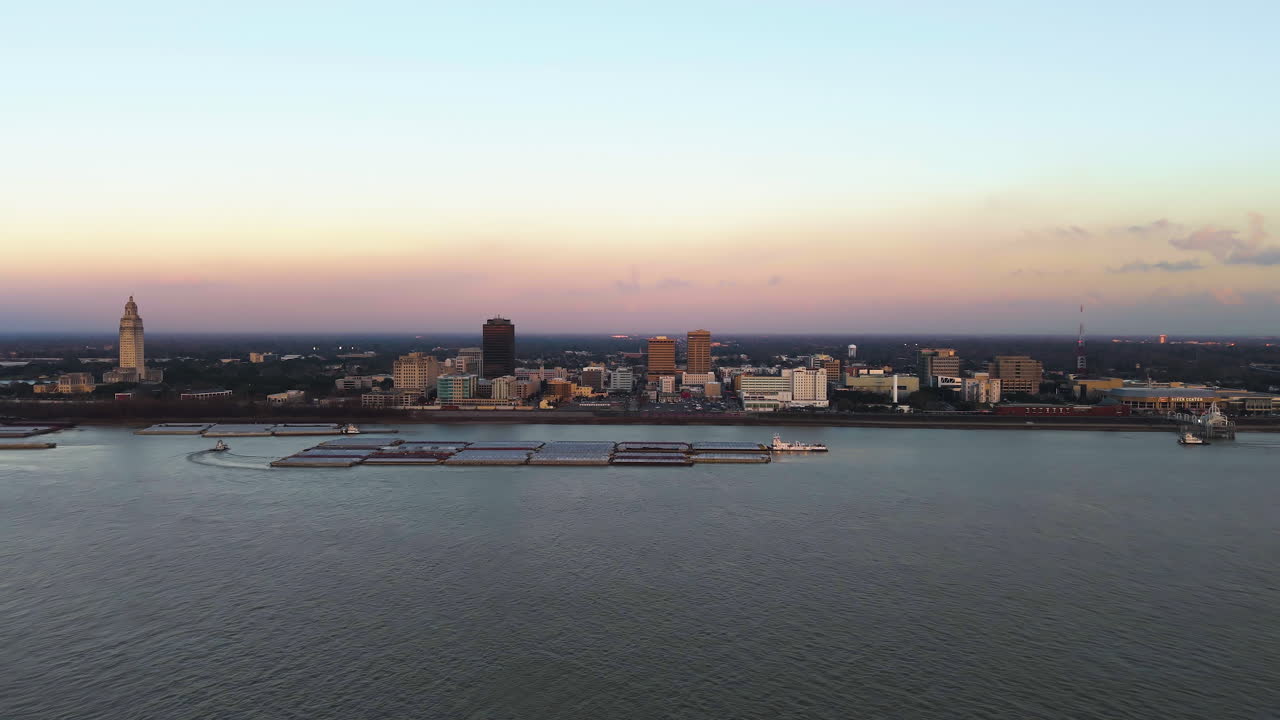 Establishing drone shot approaching the skyline of Baton Rouge, sunset in La, USA