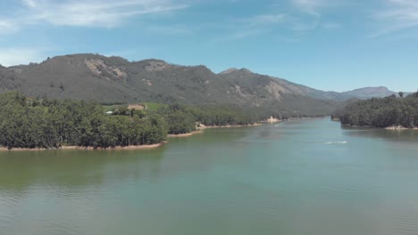 mattupetty lake beautiful scenery amidst mountainous valley in munnar, india - aerial low angle panoramic shot