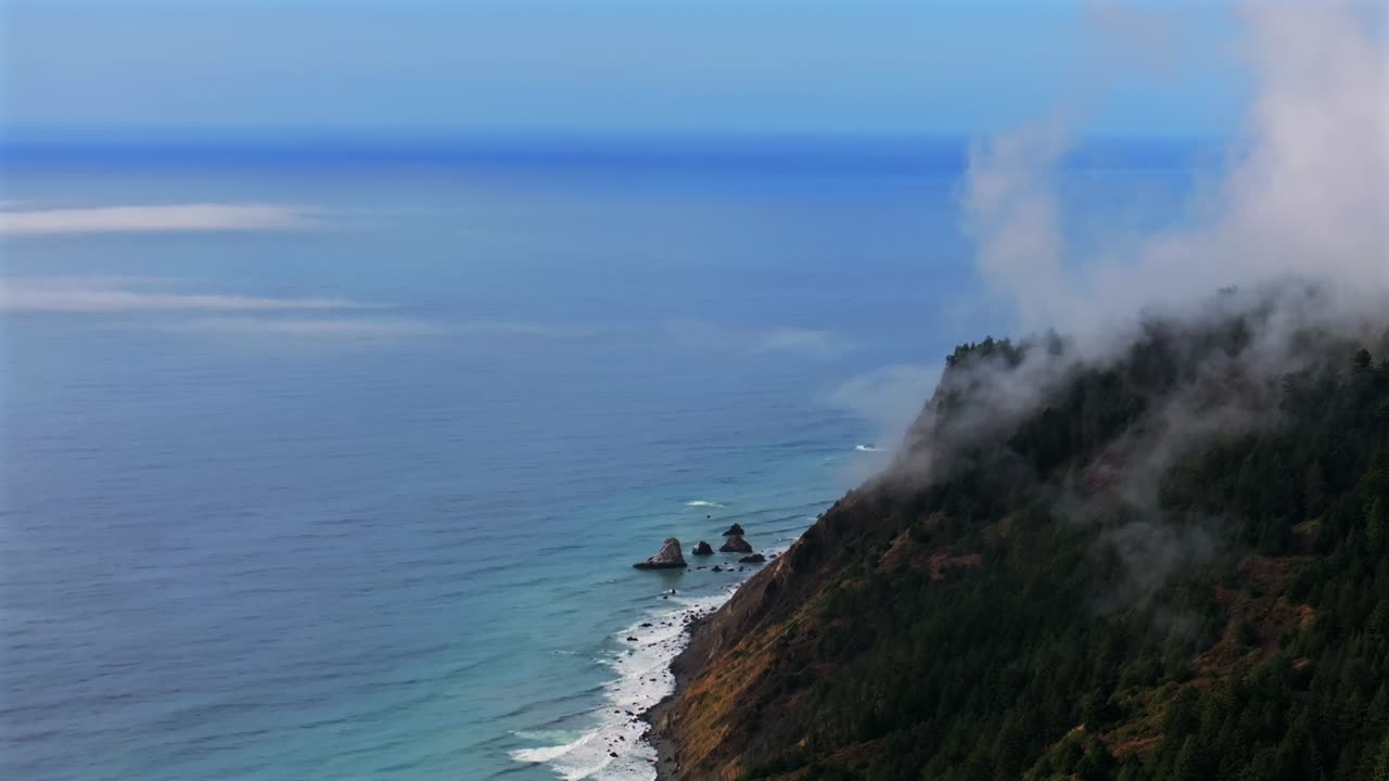 Lost Coast Trail Redwoods Sinkyone Wilderness sunny clear blue sky morning misty rugged surf rocky mountainside cliffs bluffs untouched remote USAL Beach campground California aerial drone circle left