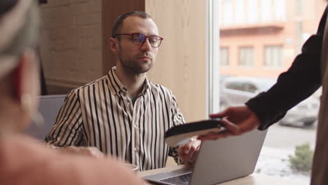 businessman working in cafe and making contactless payment
