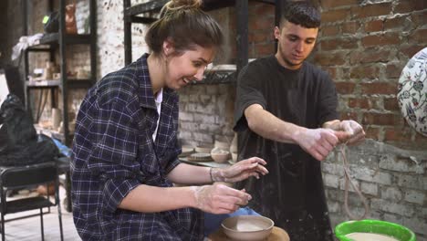 woman and man learning pottery