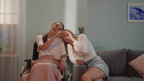 lesbian women make shape of heart with fingers showing love