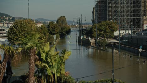 flooded city street in budapest during the 2024 flood, water covering road and signs