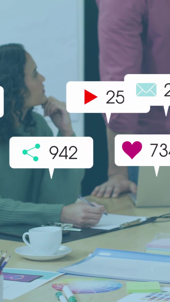 Vertical video: Woman writing while presenting, sparking icons overlaying table for business data