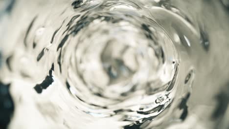 water moves in a glass in slow motion. abstract water background. seamless loop 3d render