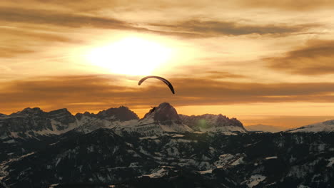 Paragliding over Snowy Alps at Sunset