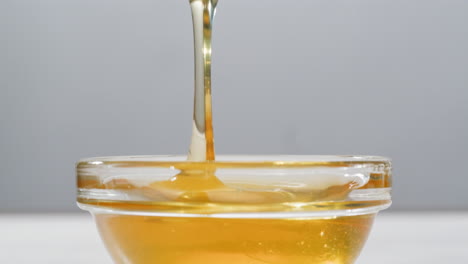 Honey pouring into a bowl