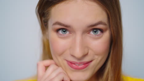 Closeup-positive-woman-sending-air-kiss-to-camera-on-grey-background.