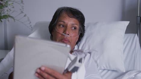 patient lying in hospital bed using tablet 4k