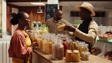 farmer with apron recommending new homemade sauce for woman