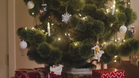 Camera-Focuses-On-Christmas-Tree-Decorated-With-Christmas-Elements-Such-As-Angels,-Snowflakes-And-Balls