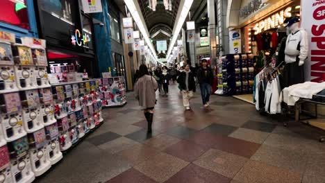 people walking through a busy shopping mall