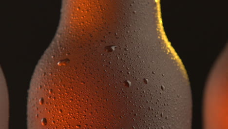 Three beer bottle rotating on black background
