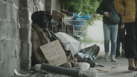 black street beggar begging passers by