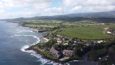 stunning panoramic aerial view capturing oceanfront resort hotels, beach, blue ocean and mountain landscape