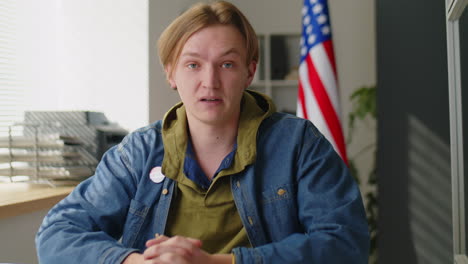 young man inviting people to take part in elections