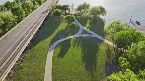 reveal shot of the lake while flying over a park near lake ray hubbard in rockwall, texas