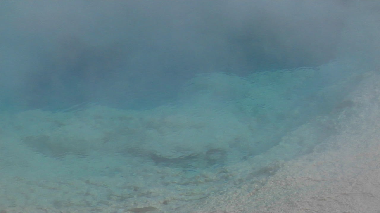 Steam Rises From A Geothermal Pool In Yellowstone National Park 3