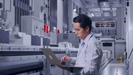 side view of an asian male professional worker use laptop at pharmaceutical factory, vaccine production facility,  he is nodding his head with dissapionted